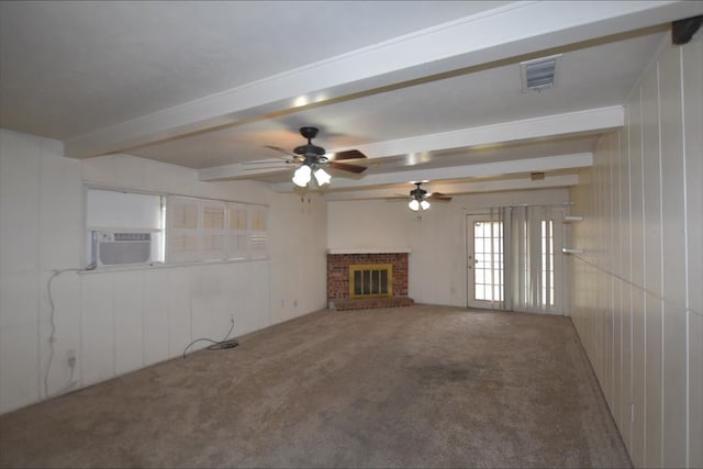 unfurnished living room with beam ceiling, ceiling fan, a brick fireplace, cooling unit, and carpet