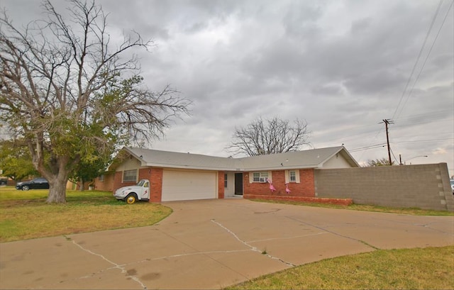 ranch-style home with a garage and a front lawn