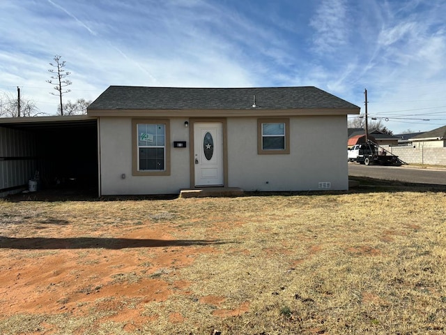 view of front of property featuring a carport