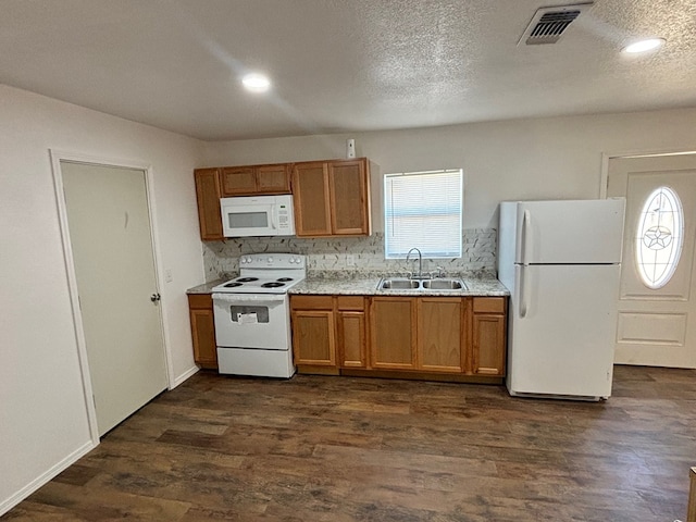 kitchen featuring a healthy amount of sunlight, white appliances, sink, and dark wood-type flooring