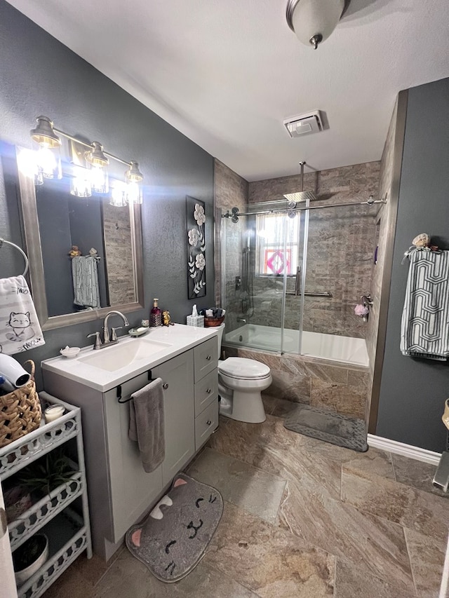 full bathroom featuring shower / bath combination with glass door, vanity, and toilet