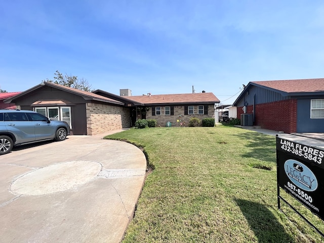 single story home featuring central air condition unit and a front yard