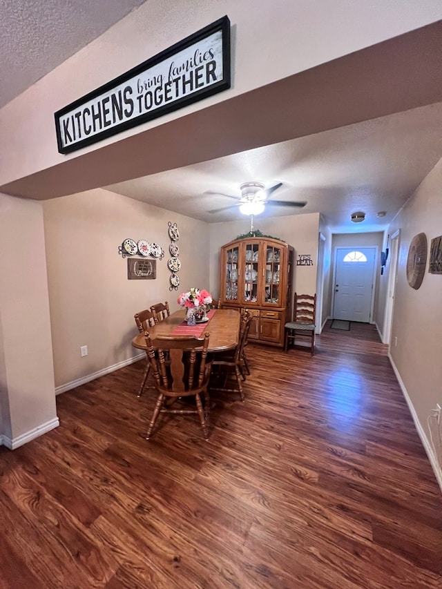 dining area with a textured ceiling, ceiling fan, and dark hardwood / wood-style floors