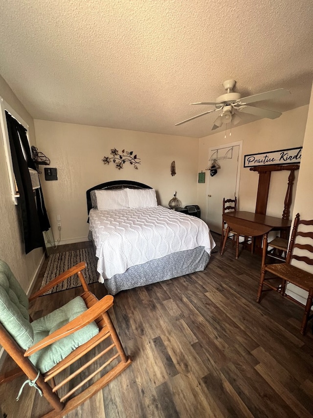 bedroom with ceiling fan, dark hardwood / wood-style floors, and a textured ceiling