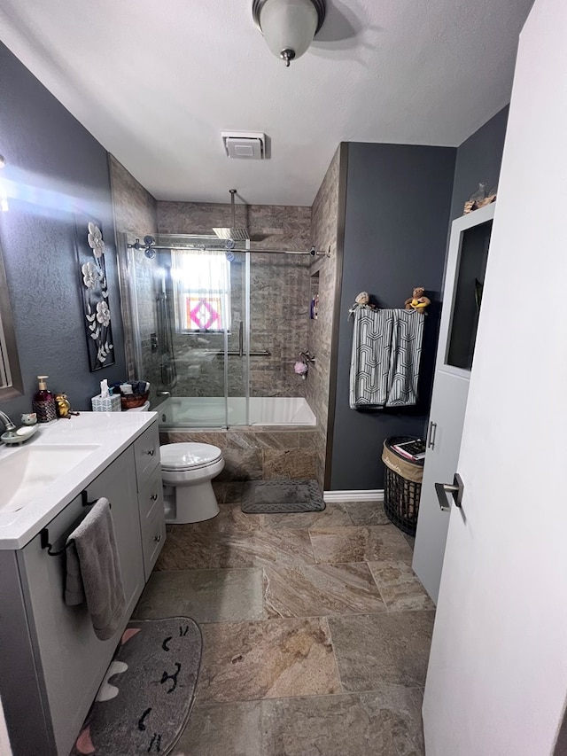 full bathroom featuring toilet, vanity, and combined bath / shower with glass door