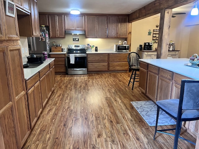 kitchen with stainless steel appliances and dark hardwood / wood-style floors