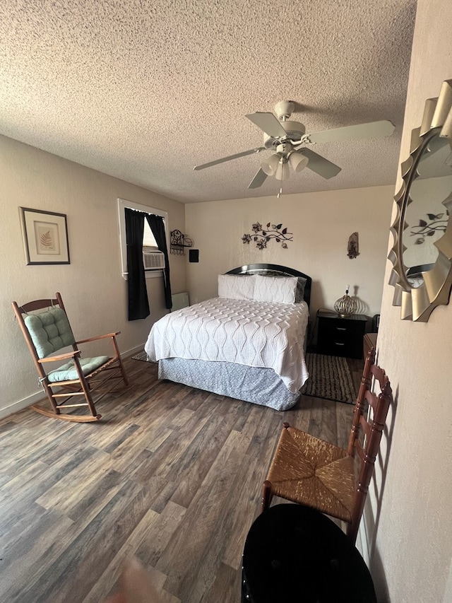 bedroom with a textured ceiling, dark hardwood / wood-style floors, and ceiling fan