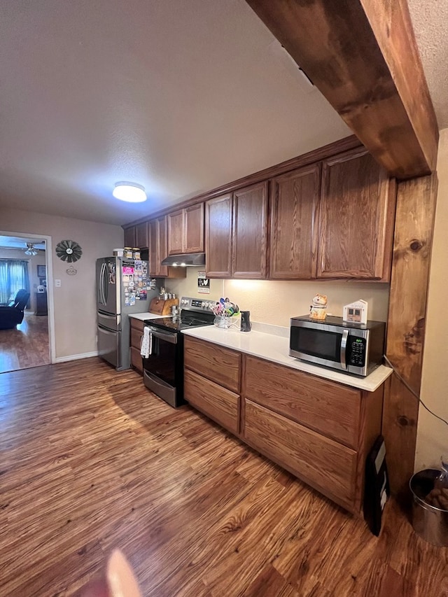 kitchen with ceiling fan, light hardwood / wood-style flooring, a textured ceiling, and appliances with stainless steel finishes