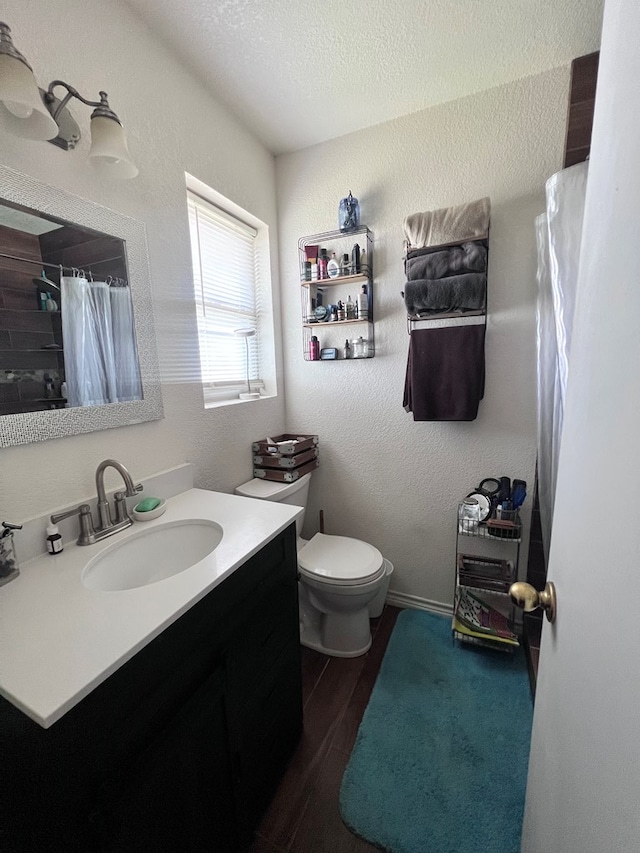 bathroom with a textured ceiling, toilet, hardwood / wood-style flooring, vanity, and a shower with shower curtain