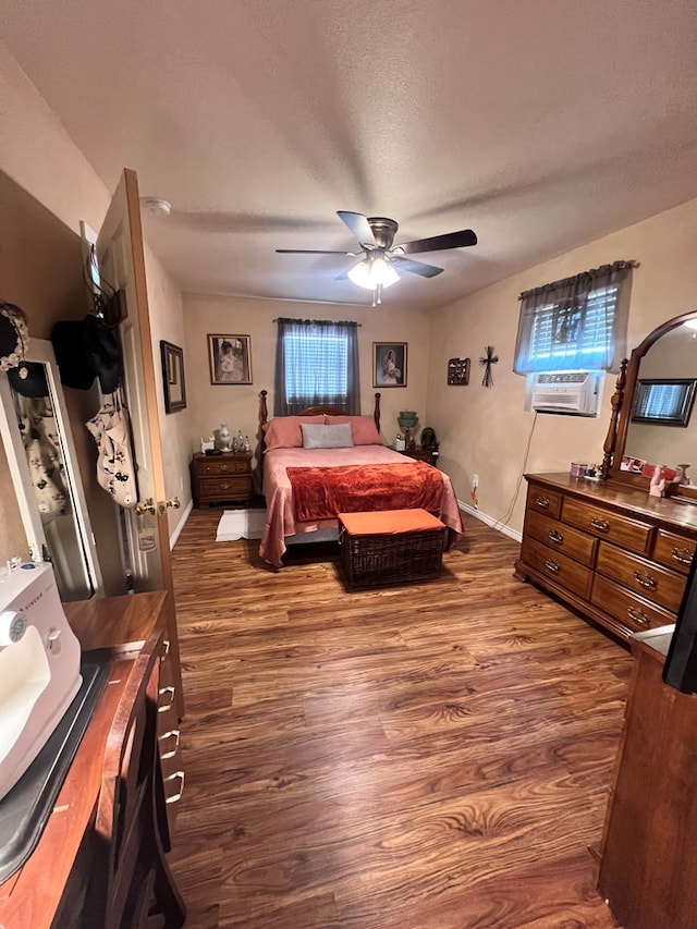 bedroom featuring a textured ceiling, ceiling fan, cooling unit, and dark wood-type flooring