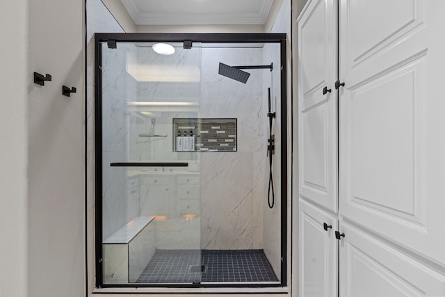 bathroom with a shower with shower door and ornamental molding