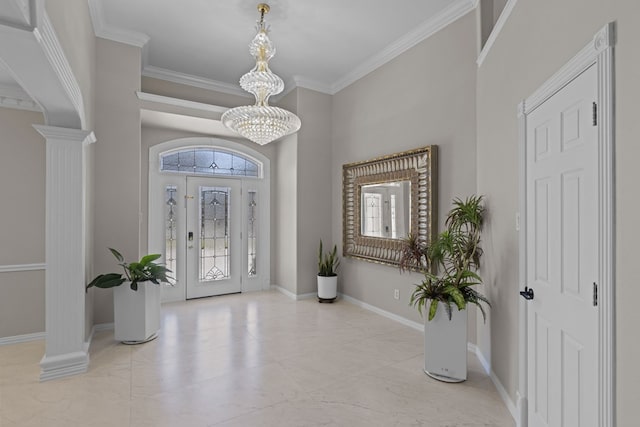 entryway with decorative columns, crown molding, and a notable chandelier