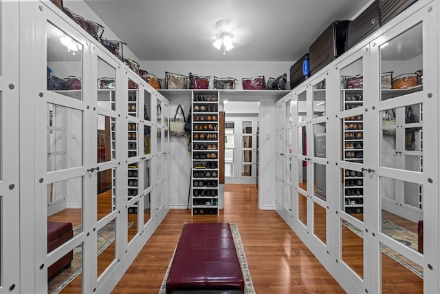 walk in closet featuring hardwood / wood-style floors and french doors