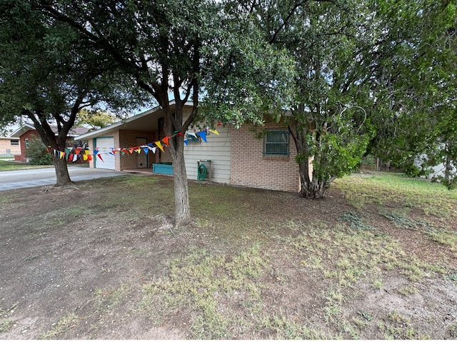 view of front of property featuring a garage and a carport