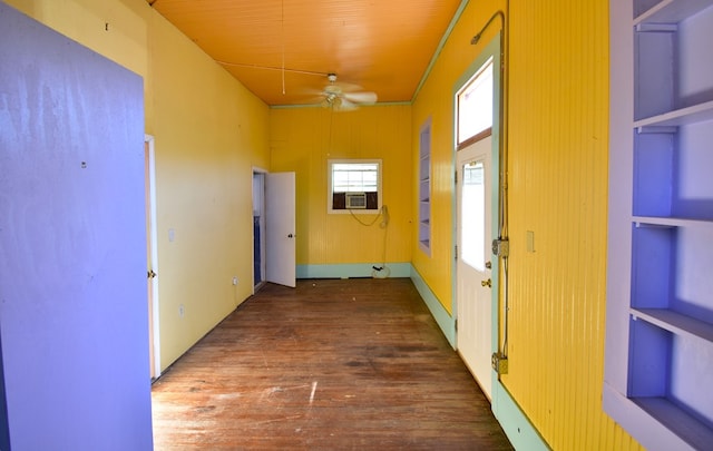 hall with dark hardwood / wood-style floors, built in features, and cooling unit