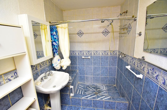 bathroom with walk in shower and tile walls