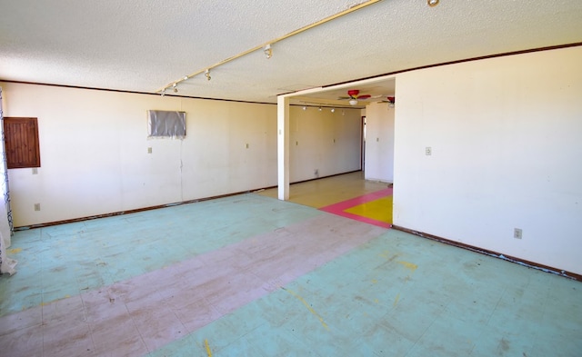 empty room with a textured ceiling and ceiling fan