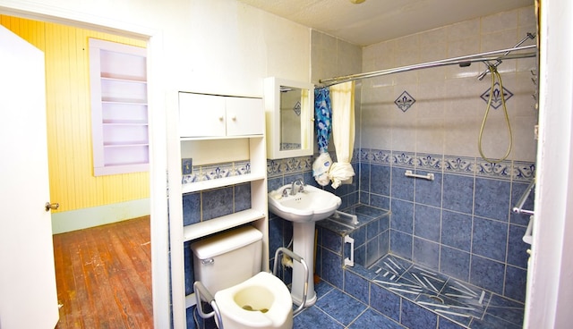 bathroom featuring sink, toilet, a shower with shower curtain, and hardwood / wood-style flooring