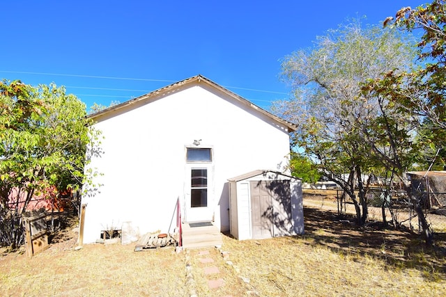 rear view of property with a shed