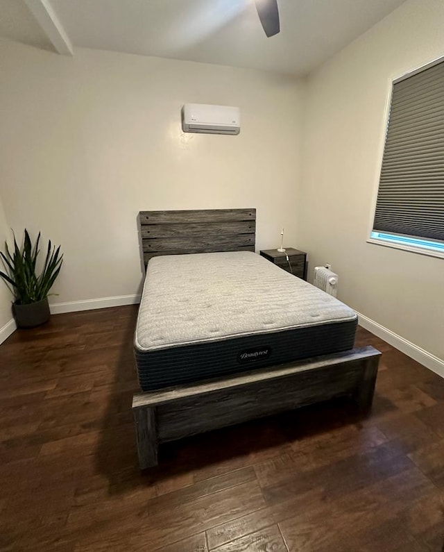 bedroom with a wall mounted air conditioner, radiator, dark hardwood / wood-style floors, and ceiling fan