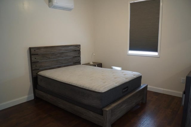 bedroom featuring dark wood-type flooring and a wall mounted AC