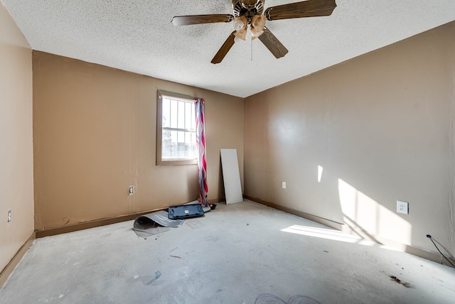 empty room featuring ceiling fan and a textured ceiling