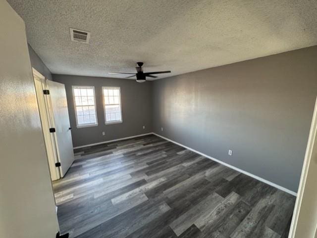 spare room featuring a textured ceiling, ceiling fan, and dark hardwood / wood-style floors