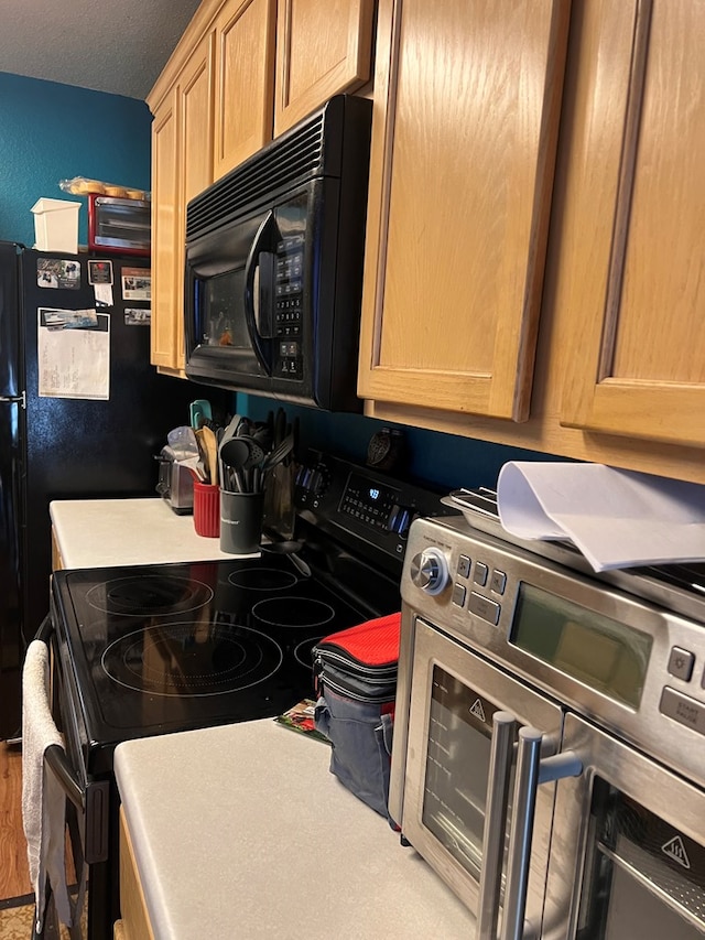 kitchen with a textured ceiling and stainless steel electric stove