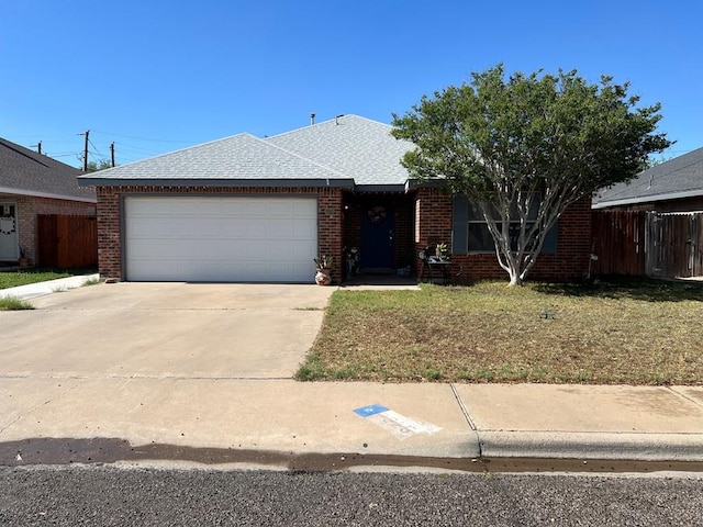 ranch-style house with a garage and a front lawn