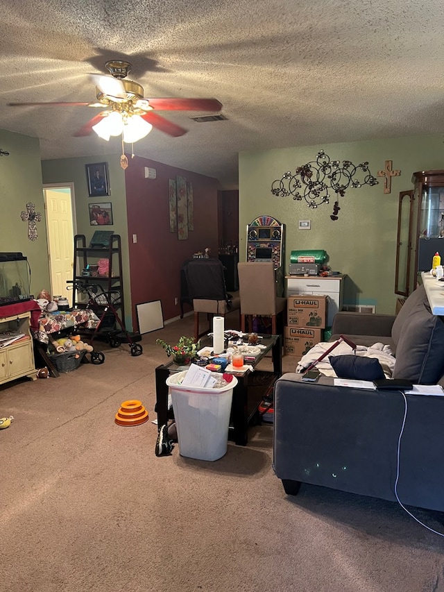 living room with ceiling fan and a textured ceiling