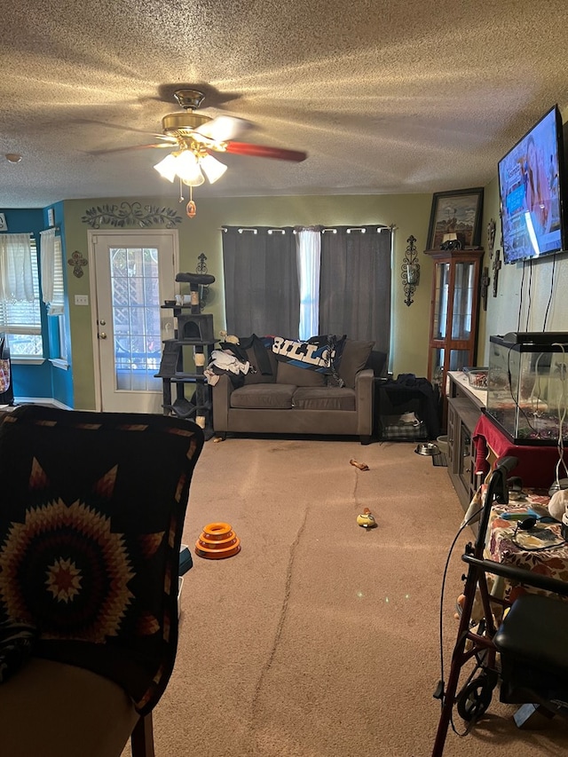 living room featuring a textured ceiling and ceiling fan