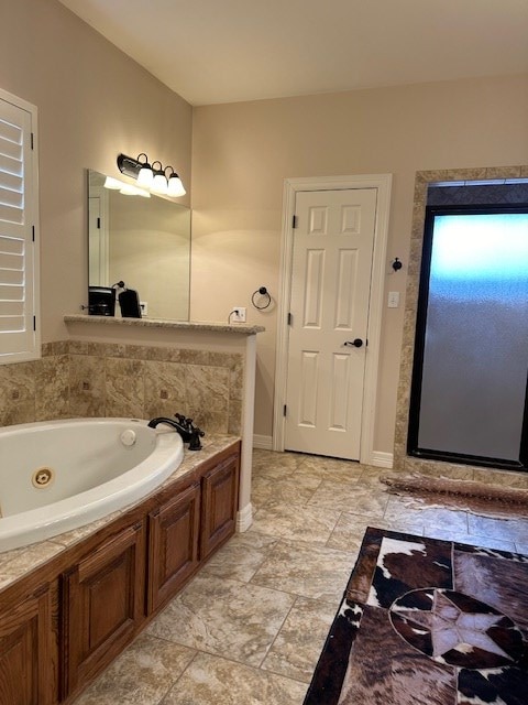 bathroom featuring a jetted tub and baseboards