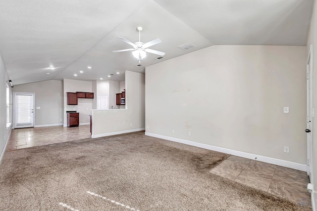 unfurnished living room featuring tile patterned flooring, vaulted ceiling, and ceiling fan