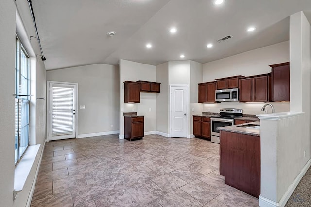 kitchen with vaulted ceiling, appliances with stainless steel finishes, and sink