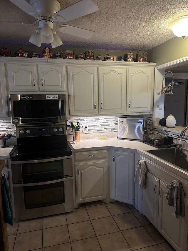 kitchen featuring white cabinetry, stainless steel appliances, and a sink