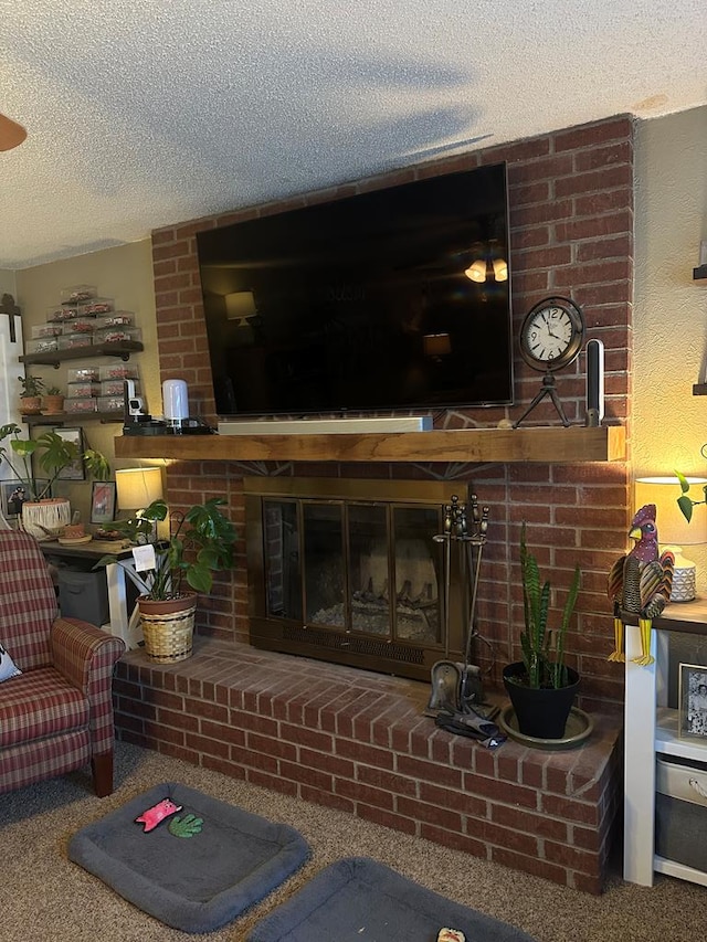 living area featuring carpet floors, a fireplace, and a textured ceiling