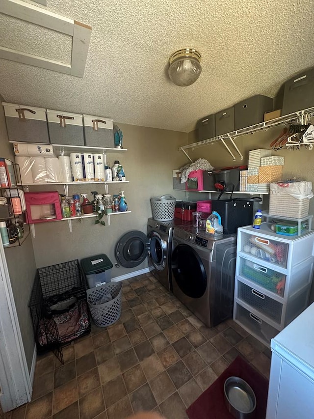 washroom with laundry area, baseboards, separate washer and dryer, and a textured ceiling