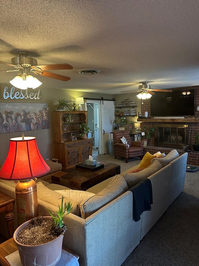 living room with carpet, visible vents, ceiling fan, and a textured ceiling