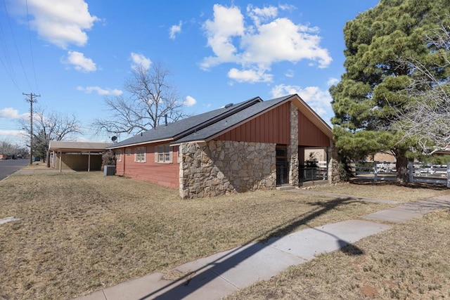 view of side of property featuring central AC unit and stone siding