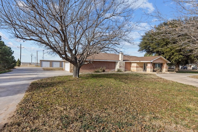 ranch-style home with a front lawn and a garage