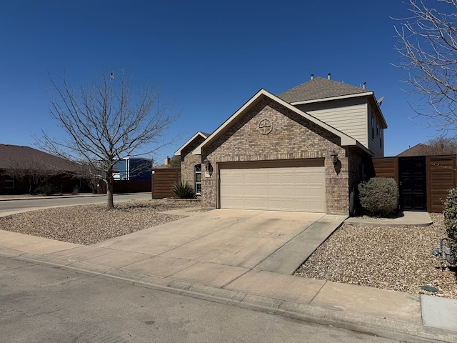 view of front of home with brick siding, driveway, and a garage