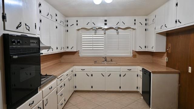 kitchen featuring black appliances and white cabinets