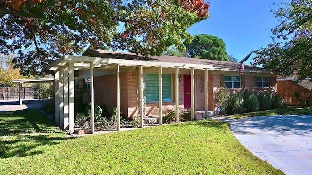 single story home featuring a front yard and a carport