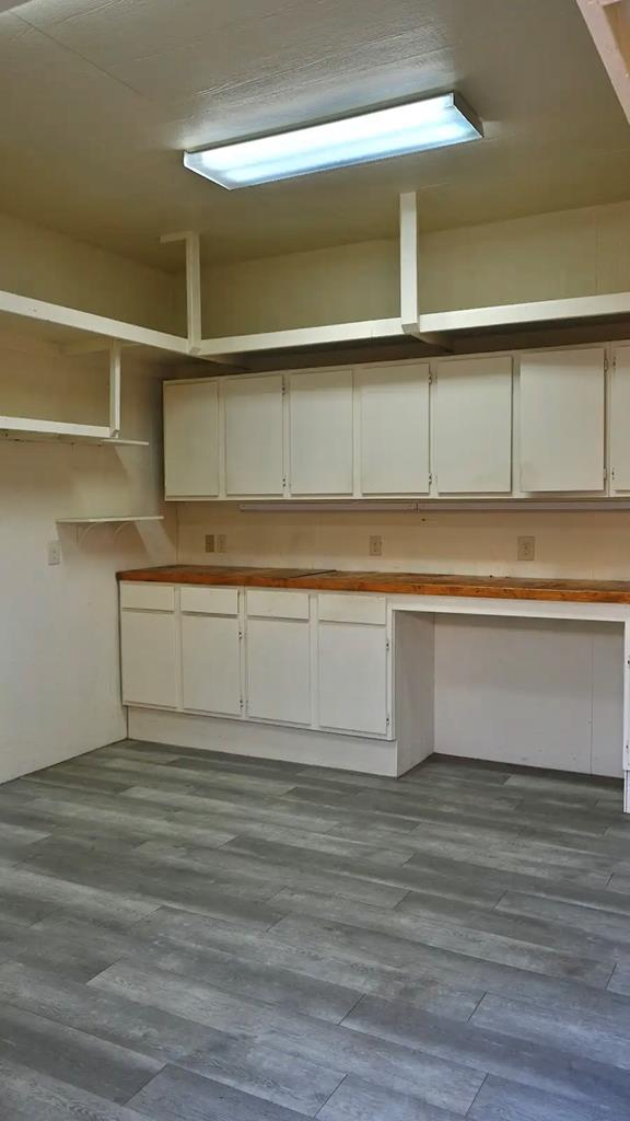 interior space featuring hardwood / wood-style flooring and built in desk