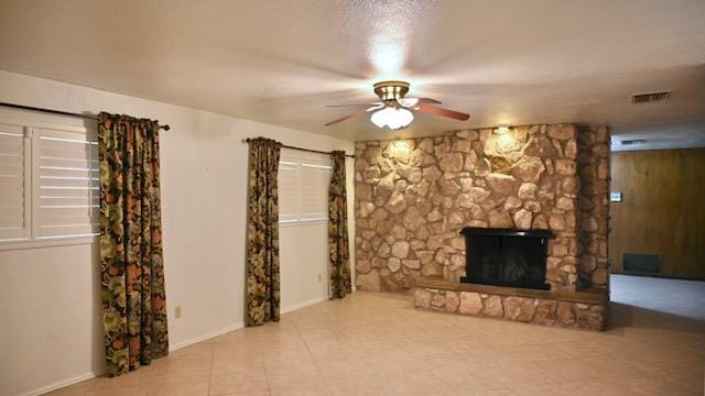 unfurnished living room with a fireplace and ceiling fan