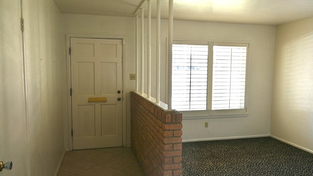 hall with dark tile patterned floors