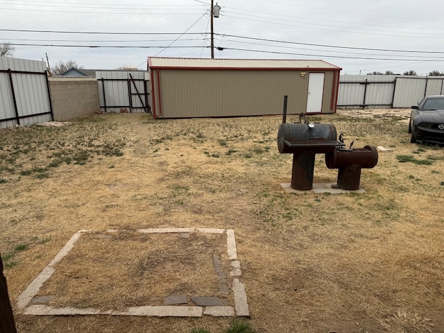 view of yard featuring an outbuilding, an outdoor structure, and fence