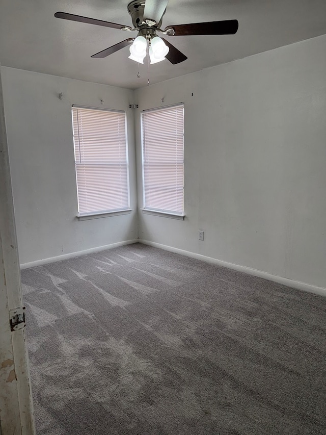 unfurnished room featuring carpet flooring, baseboards, and ceiling fan