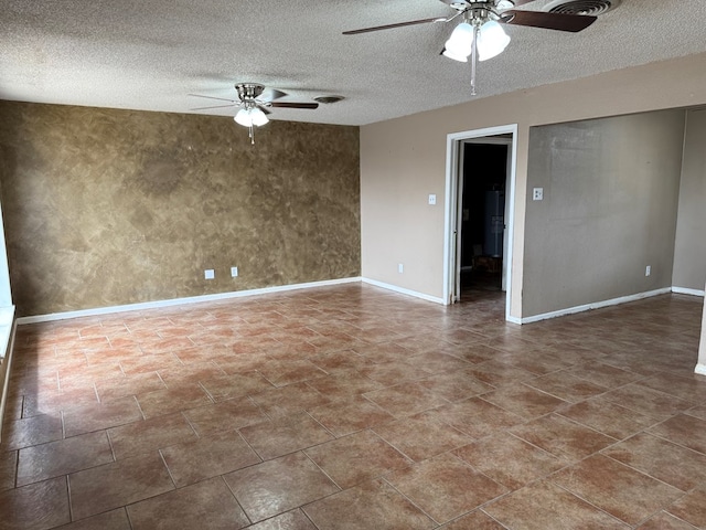 spare room featuring a textured ceiling, baseboards, and ceiling fan