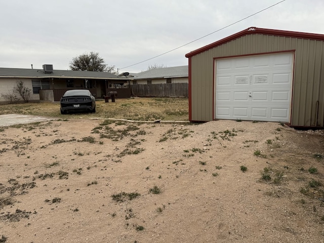 exterior space with central AC, driveway, and fence